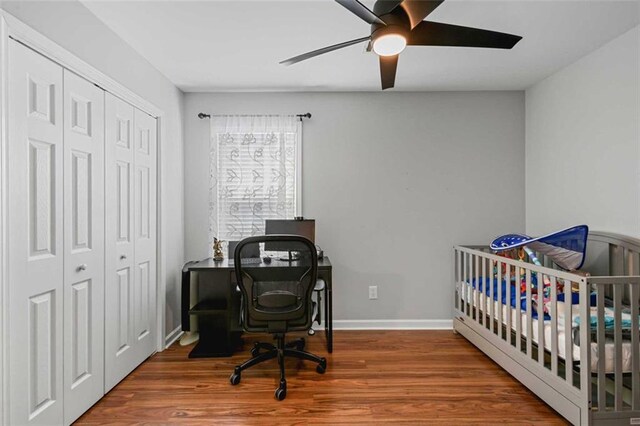 2203 Arbor Hill Rd, Canton, GA 30115 - bedroom featuring a closet, wood finished floors, ceiling fan, a crib, and baseboards