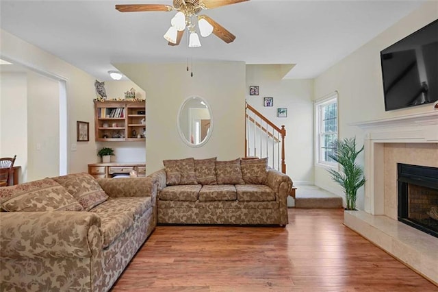 2203 Arbor Hill Rd, Canton, GA 30115 - living area with wood finished floors, a fireplace, stairs, and ceiling fan