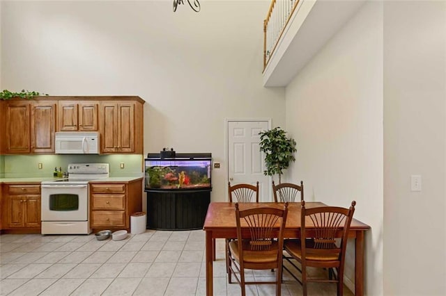 2203 Arbor Hill Rd, Canton, GA 30115 - dining room featuring a high ceiling and light tile patterned floors