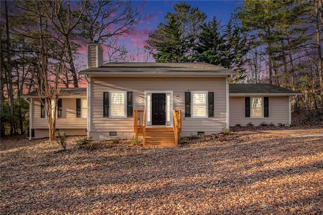 view of front of property featuring crawl space and a chimney