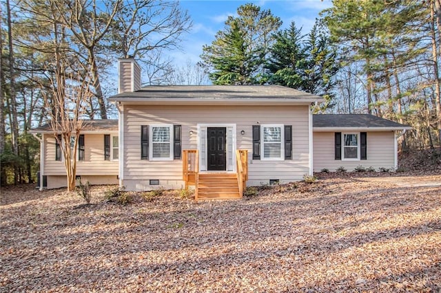 view of front facade featuring crawl space and a chimney