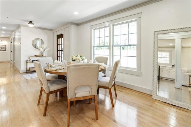 dining area featuring crown molding, decorative columns, recessed lighting, light wood-style flooring, and baseboards