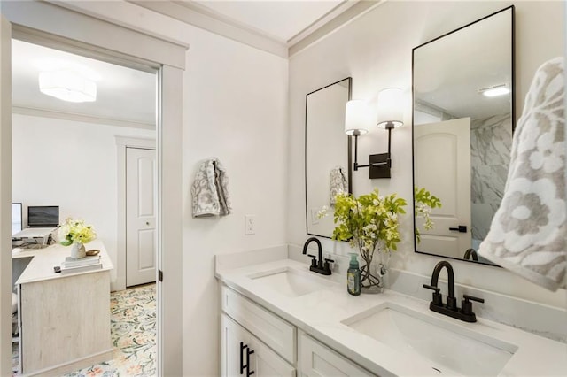 bathroom with ornamental molding, a sink, and double vanity