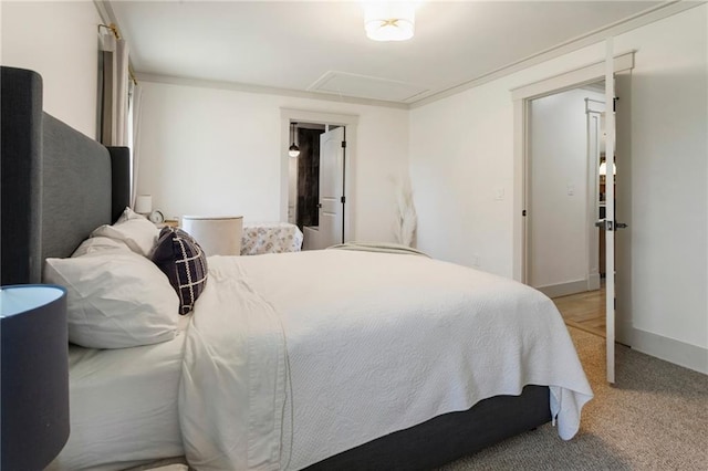 bedroom featuring light carpet, attic access, and baseboards