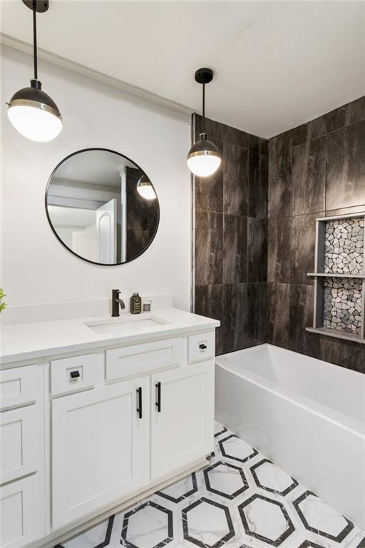 bathroom with bathing tub / shower combination and vanity