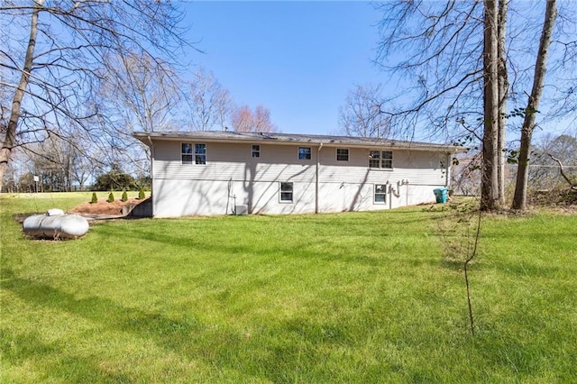 rear view of property with a lawn