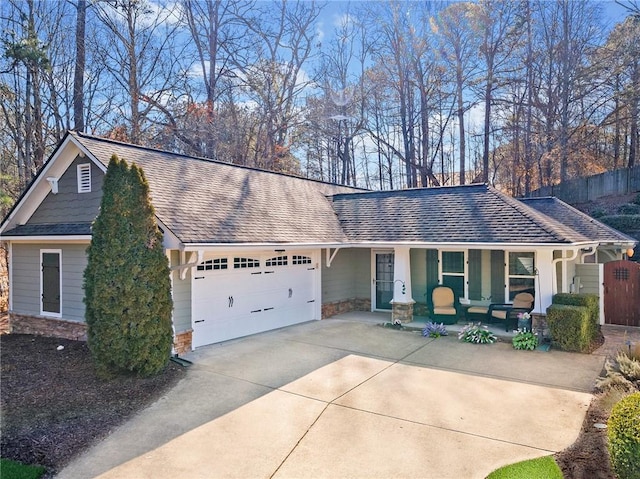 single story home featuring a garage and a porch