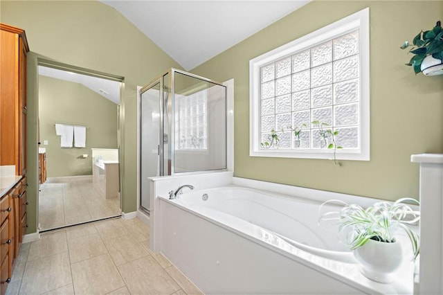 bathroom with tile patterned floors, vanity, independent shower and bath, and vaulted ceiling