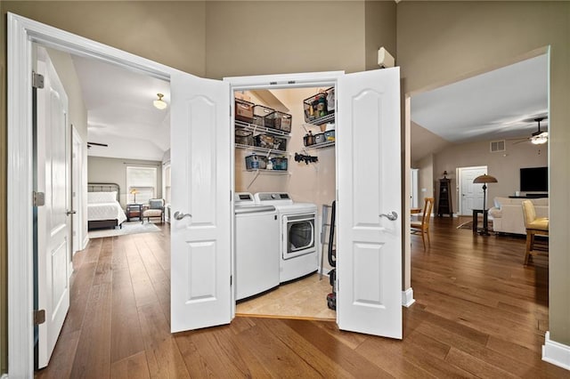 laundry area featuring ceiling fan, washer and clothes dryer, and hardwood / wood-style floors