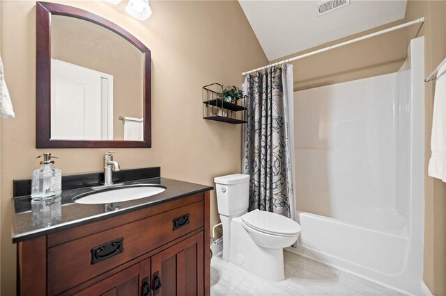 full bathroom featuring vaulted ceiling, shower / bath combination with curtain, tile patterned flooring, vanity, and toilet