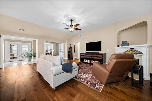 living room featuring dark wood-type flooring, french doors, and ceiling fan