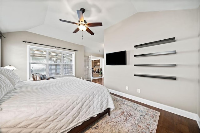 bedroom with ceiling fan, dark hardwood / wood-style flooring, and vaulted ceiling