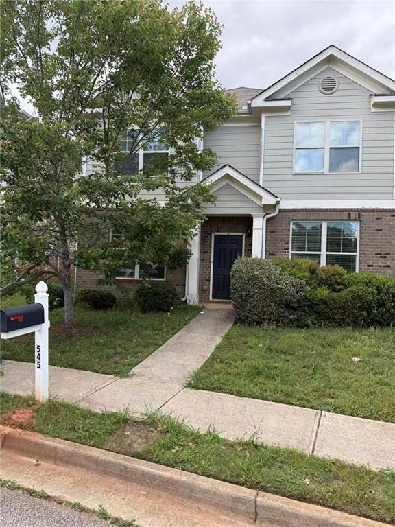 545 Tulip Ln, Mcdonough, GA 30252 - view of front of house with brick siding and a front lawn