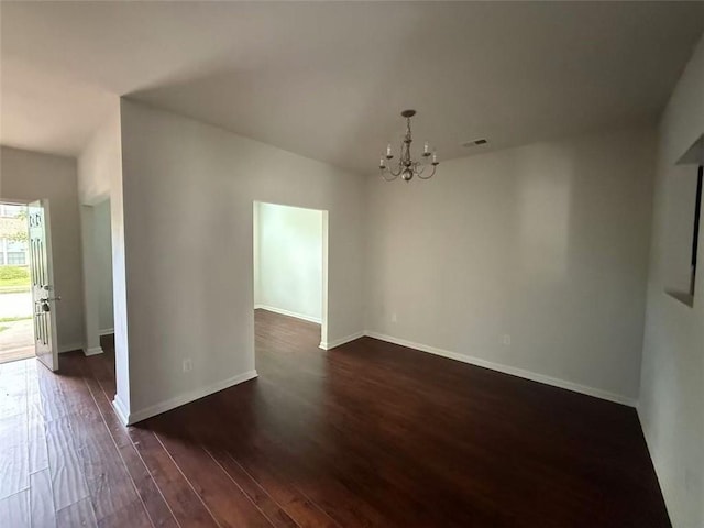 545 Tulip Ln, Mcdonough, GA 30252 - unfurnished dining area featuring a chandelier, dark wood-type flooring, and baseboards