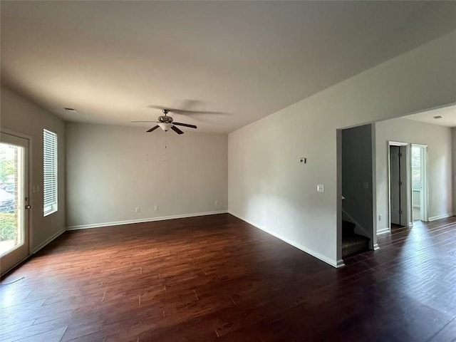 545 Tulip Ln, Mcdonough, GA 30252 - spare room with dark wood-type flooring, stairs, baseboards, and a ceiling fan