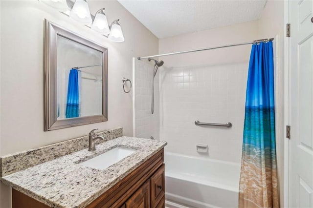 bathroom featuring a textured ceiling, shower / bath combo, and vanity