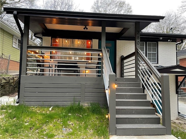 entrance to property featuring brick siding