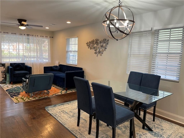 dining room featuring ceiling fan with notable chandelier, recessed lighting, wood finished floors, and baseboards