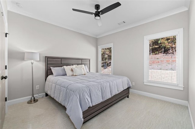 bedroom with ornamental molding, light carpet, baseboards, and visible vents