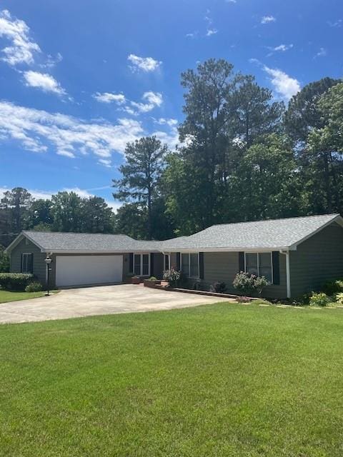 ranch-style home featuring an attached garage, driveway, and a front lawn