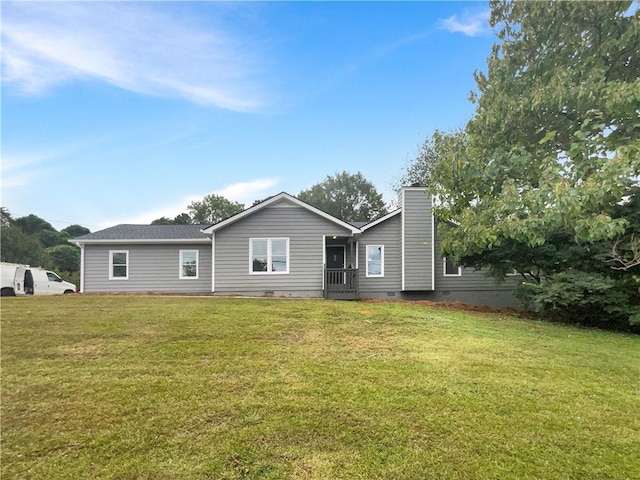 rear view of house with a yard