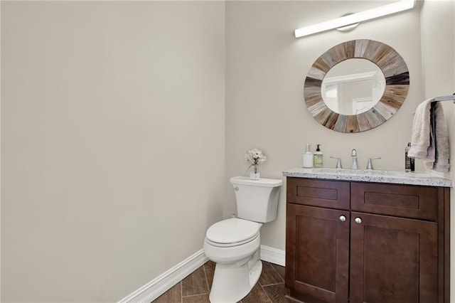 2150 Fincher Rd, Canton, GA 30114 - half bathroom with toilet, baseboards, vanity, and wood finished floors
