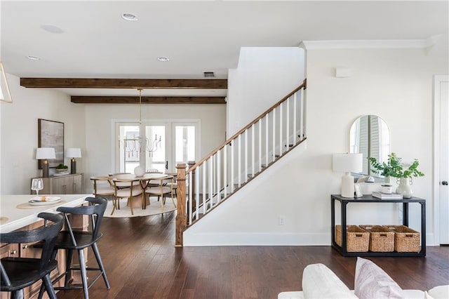 stairs featuring beam ceiling, wood-type flooring, and a chandelier