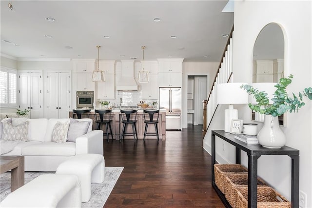 living room with dark hardwood / wood-style flooring and ornamental molding