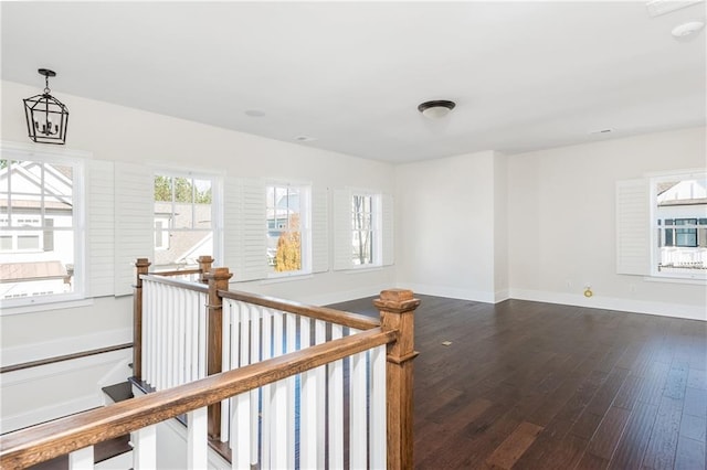 hall featuring hardwood / wood-style flooring and a notable chandelier