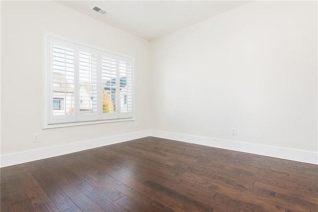 empty room featuring dark hardwood / wood-style flooring