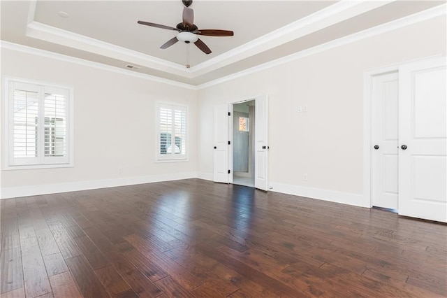 empty room featuring dark hardwood / wood-style floors, ceiling fan, and a wealth of natural light