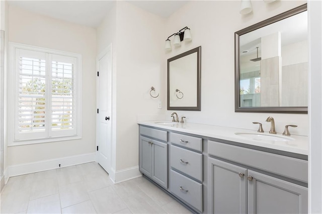 bathroom with tile patterned flooring, vanity, and walk in shower