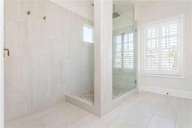 bathroom featuring a tile shower and tile patterned flooring