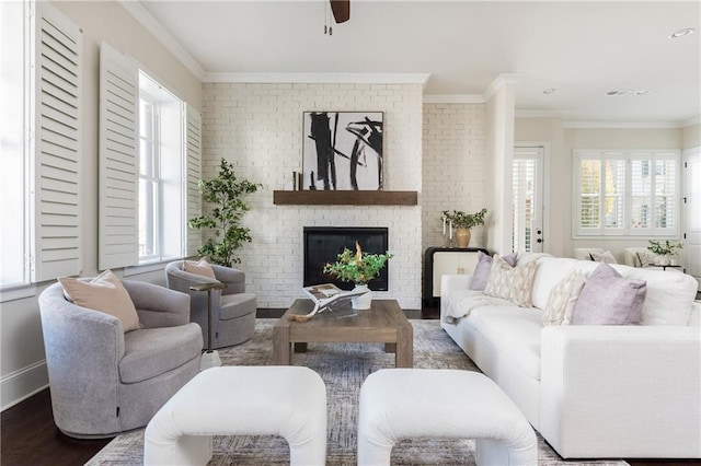 living room featuring a fireplace, hardwood / wood-style floors, ceiling fan, and crown molding