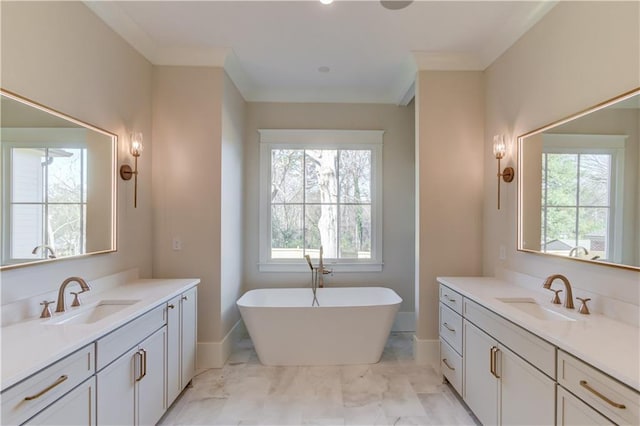 bathroom with crown molding, vanity, and a tub