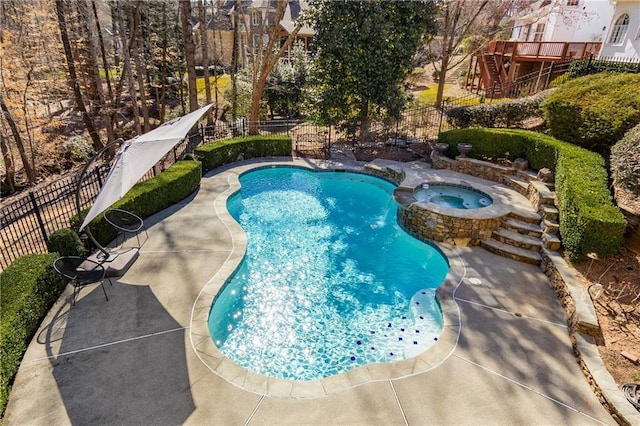 view of swimming pool with a patio area, a fenced backyard, and a pool with connected hot tub