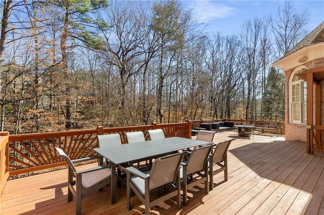 deck with a fire pit and outdoor dining area