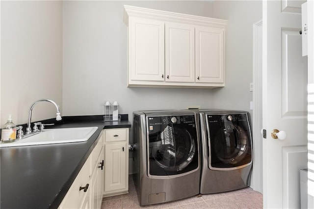 washroom with washer and clothes dryer, a sink, and cabinet space