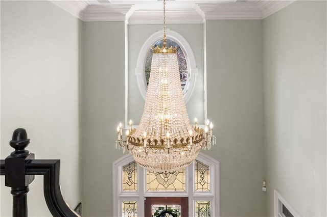 interior details with a notable chandelier and crown molding