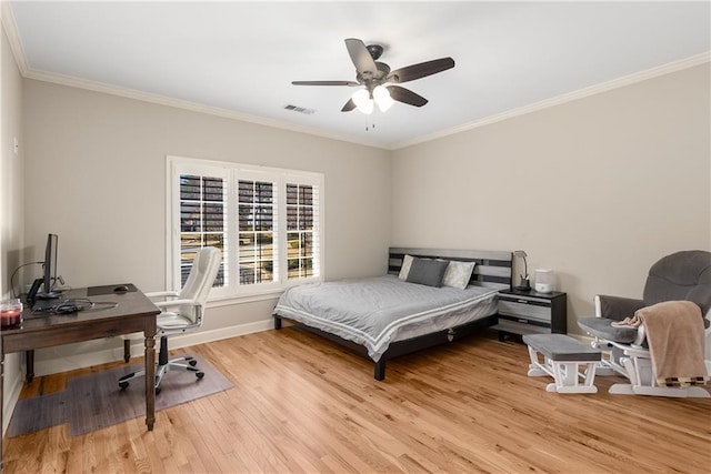 bedroom with ornamental molding, visible vents, and wood finished floors