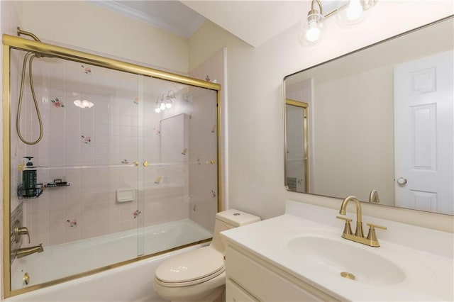 full bathroom featuring combined bath / shower with glass door, crown molding, vanity, and toilet