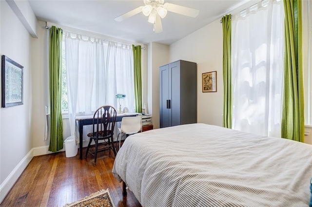 bedroom featuring hardwood / wood-style flooring, baseboards, and a ceiling fan