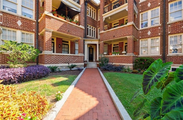 entrance to property featuring brick siding