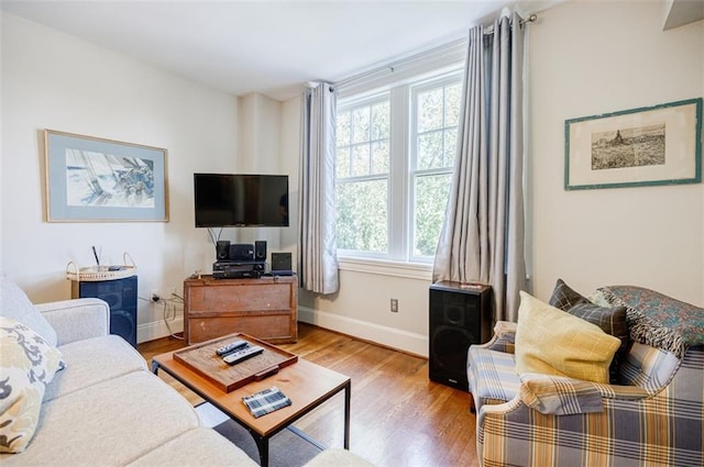living room featuring wood finished floors and baseboards