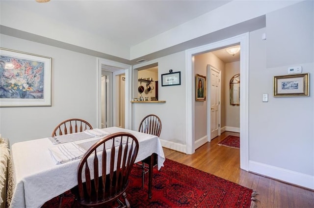 dining room featuring baseboards and wood finished floors