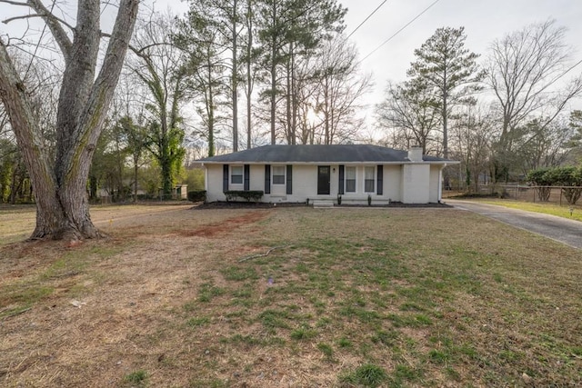 ranch-style house with a front lawn