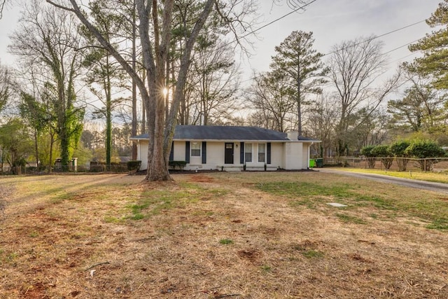 ranch-style home with a front lawn