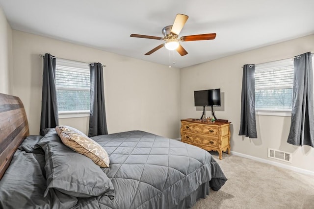 bedroom featuring light carpet and ceiling fan