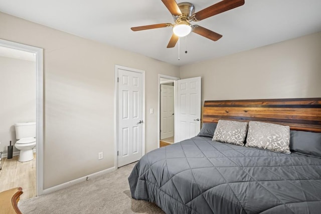 bedroom featuring light carpet, ceiling fan, and ensuite bathroom