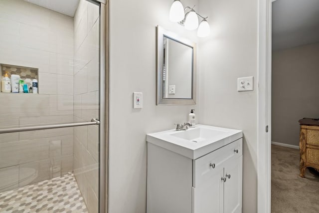 bathroom featuring vanity and an enclosed shower